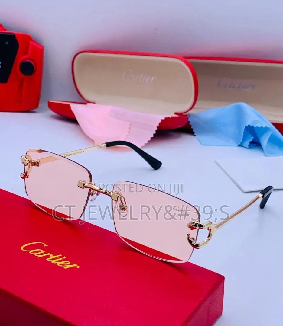 Cartier Sunglasses Featuring a Gold Frame and Blue Tinted Lenses.