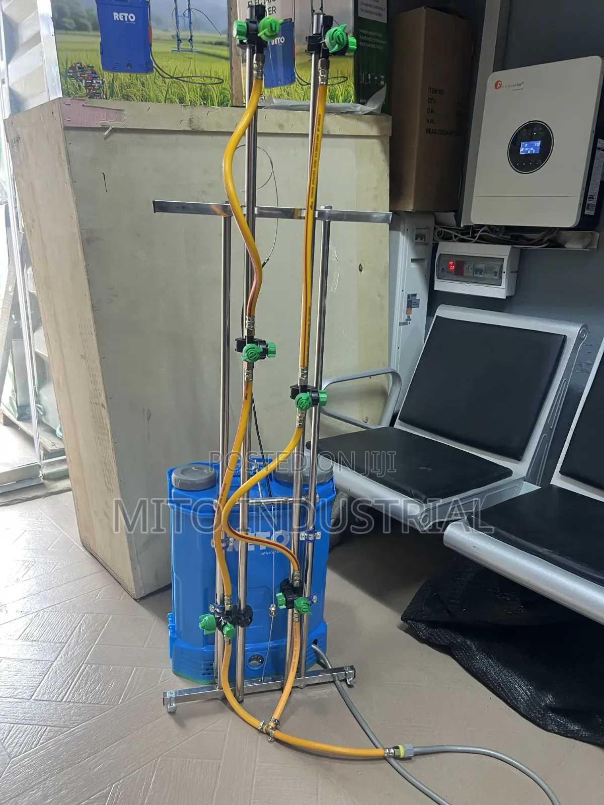Battery Knapsack Sprayer With an Extended Vertical Boom Attachment.