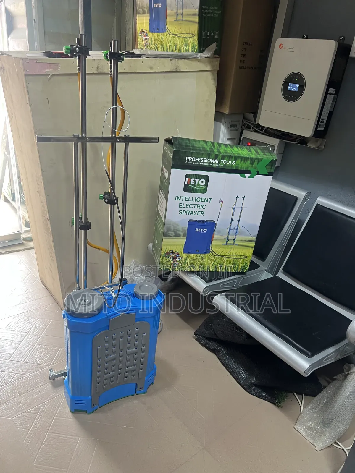 Battery Knapsack Sprayer With an Extended Vertical Boom Attachment.