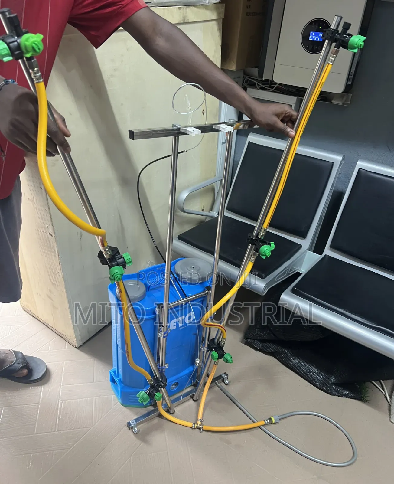 Battery Knapsack Sprayer With an Extended Vertical Boom Attachment.