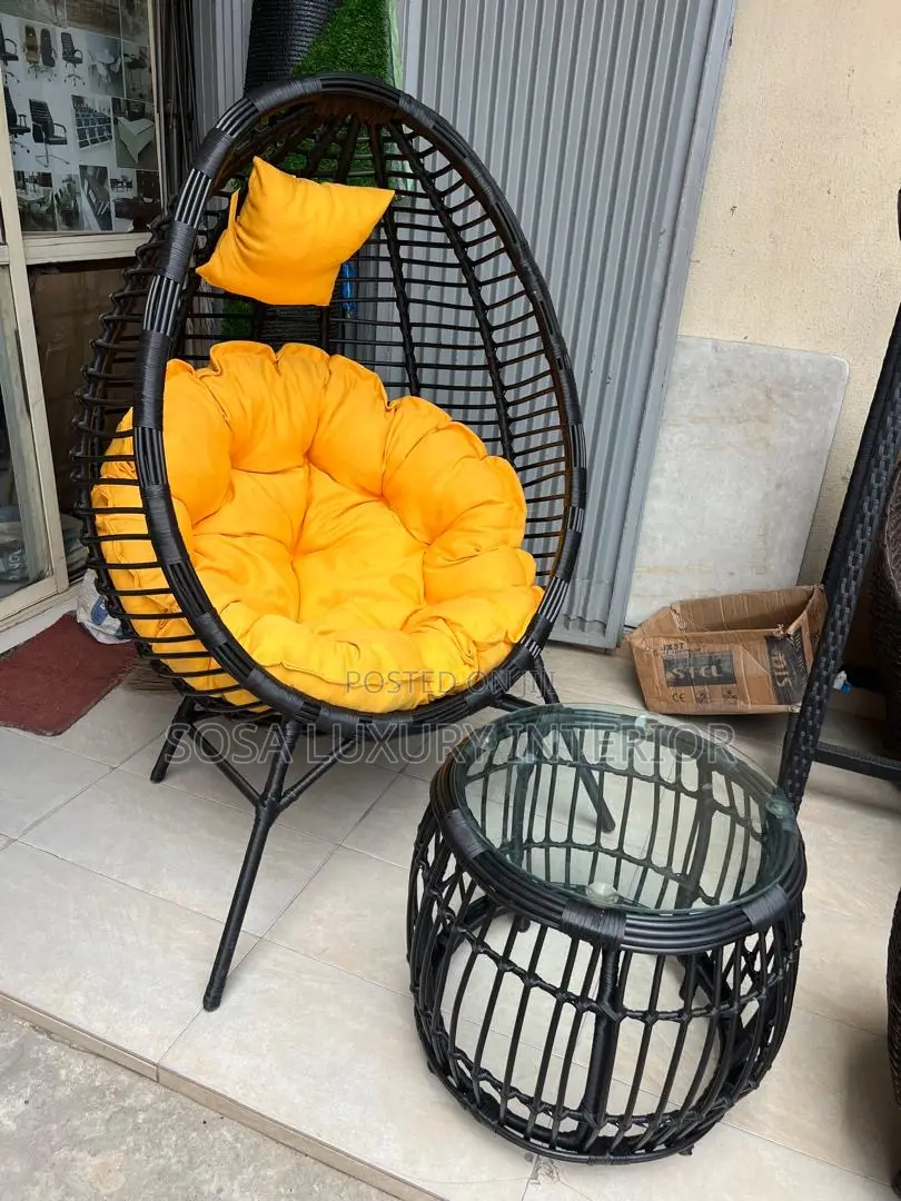 Odern Black Wicker Hanging Egg Chair With Yellow Cushion and Table