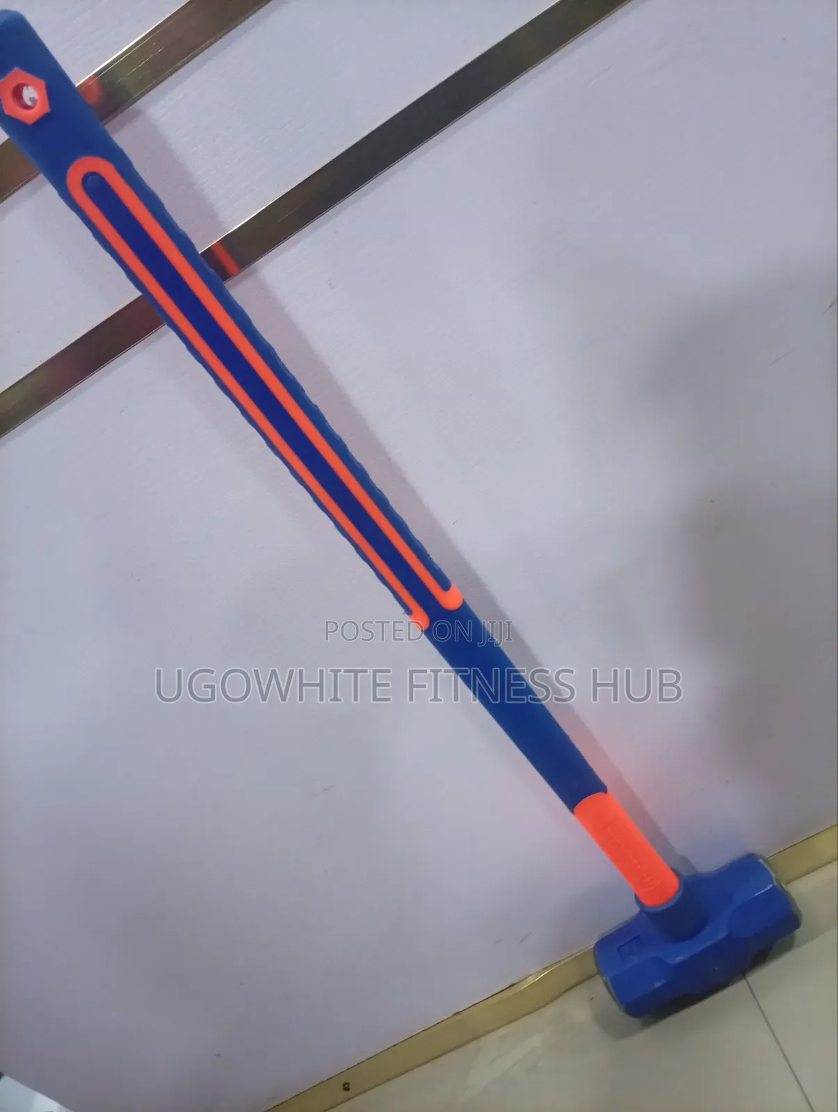 Features A 12-pound (12 Lb) Sledgehammer With A Bright Orange