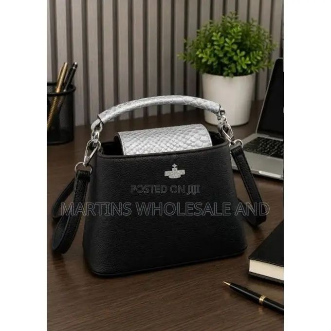 Miss Gail Bag Features Silver Hardware and a Top Handle.