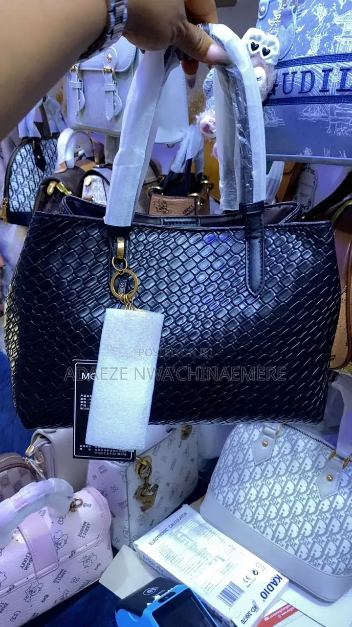 This Black Woven Tote Bag Features a Distinct Latticed Texture