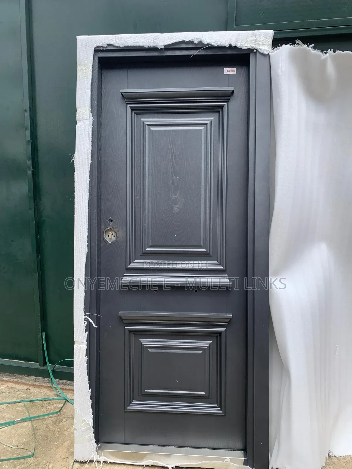 Dark Gray Favida Security Door With a Decorative Panel Design