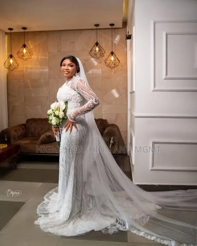 White Sequin-Encrusted Mermaid Bridal Gown With Illusion Sleeves.