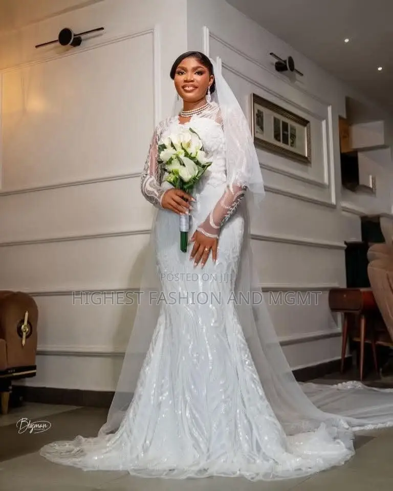 White Sequin-Encrusted Mermaid Bridal Gown With Illusion Sleeves.