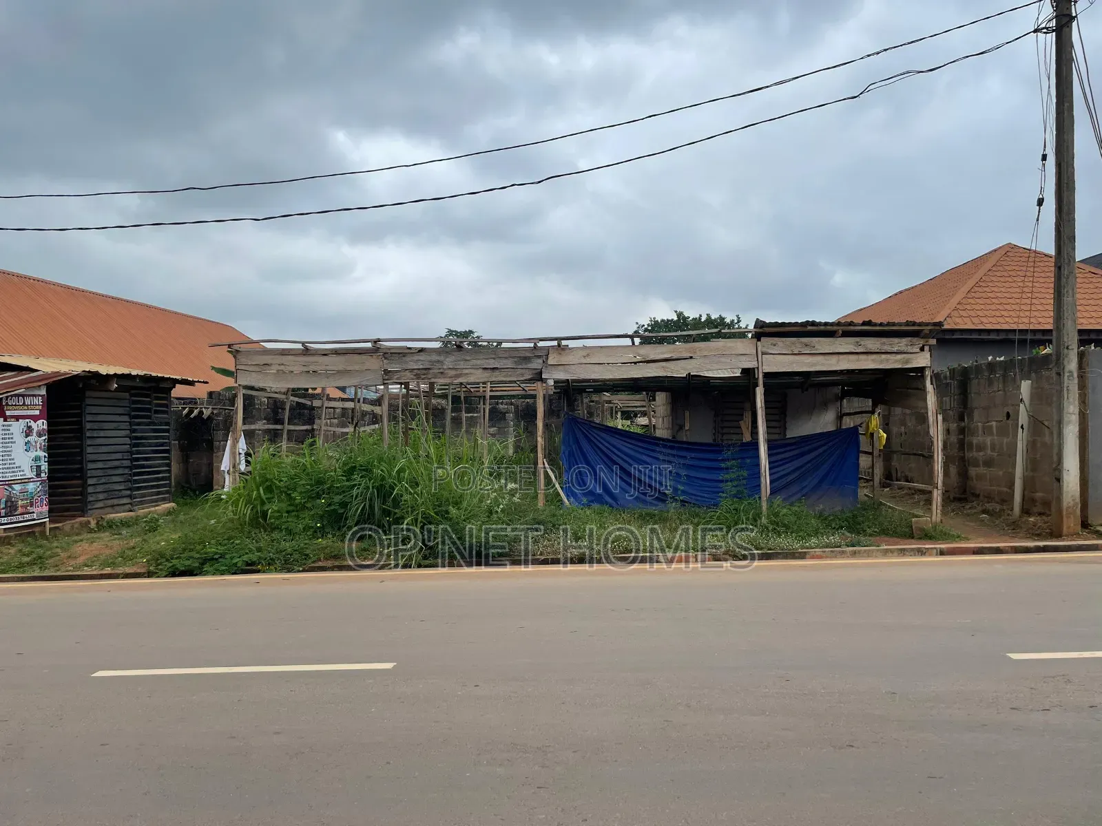 A Plot of Land With an Uncompleted Building Facing a Major Road