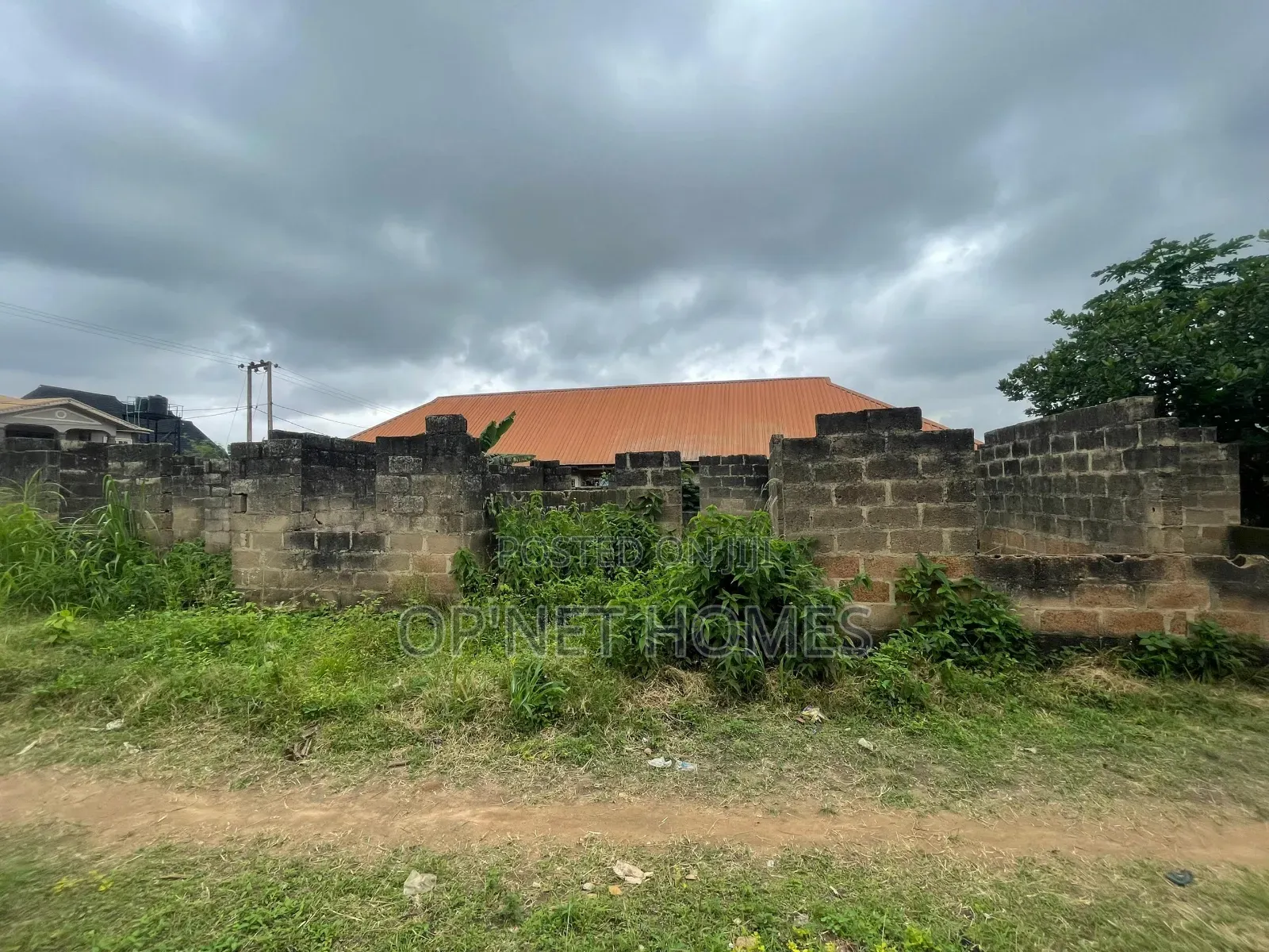 A Plot of Land With an Uncompleted Building Facing a Major Road
