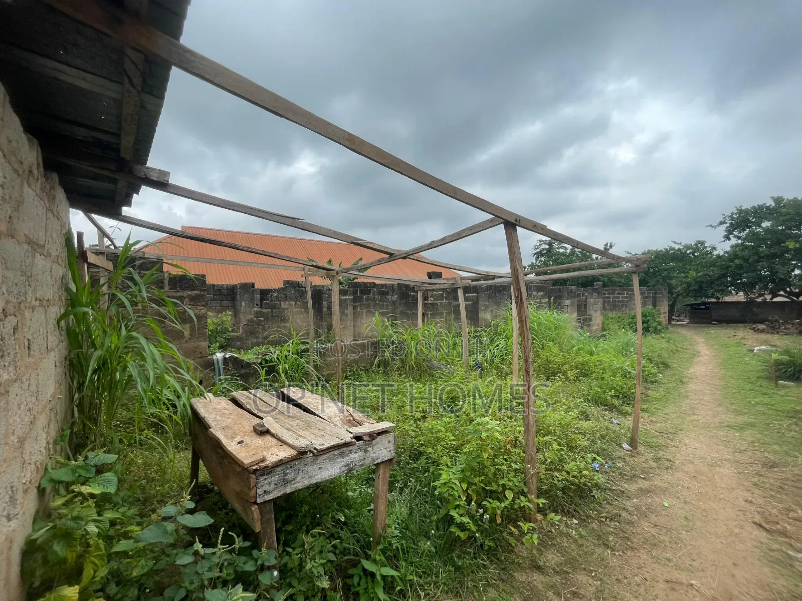 A Plot of Land With an Uncompleted Building Facing a Major Road
