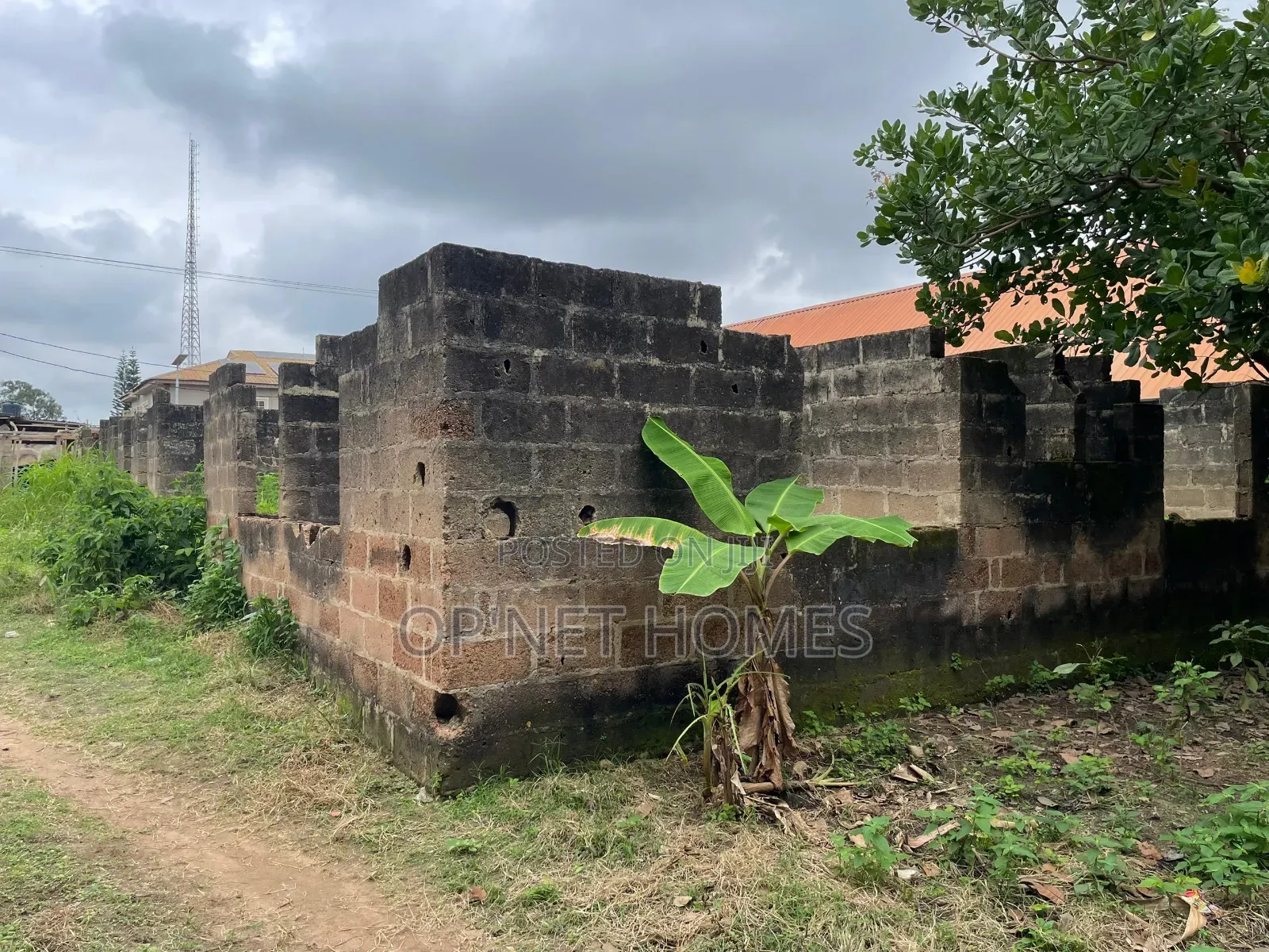 A Plot of Land With an Uncompleted Building Facing a Major Road
