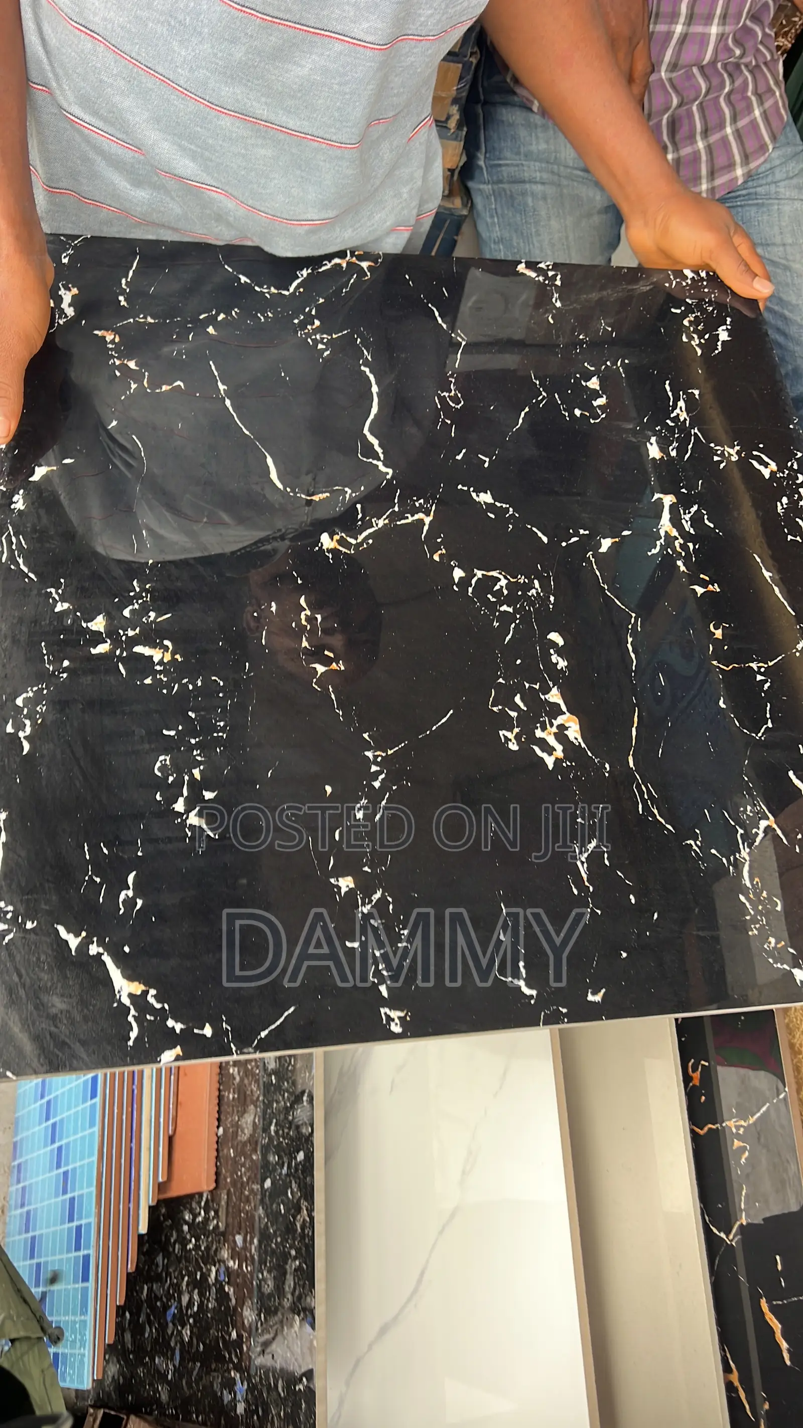 Black Polished Floor Tile Features White and Gold-Colored Veining