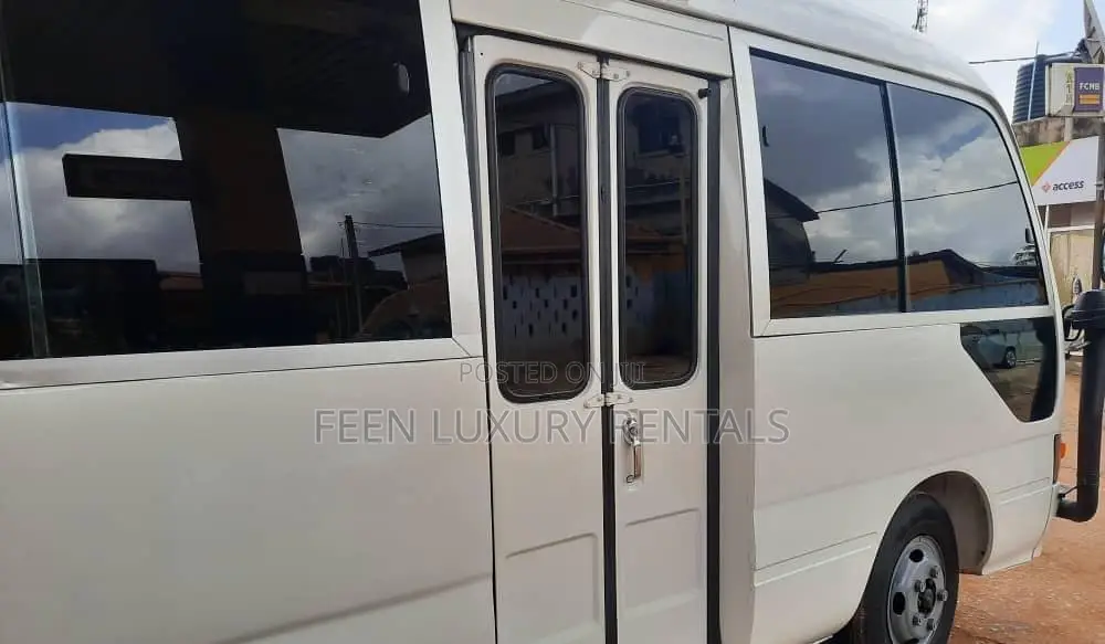 White Toyota Coaster Minibus for Rent | Minibus for Hire