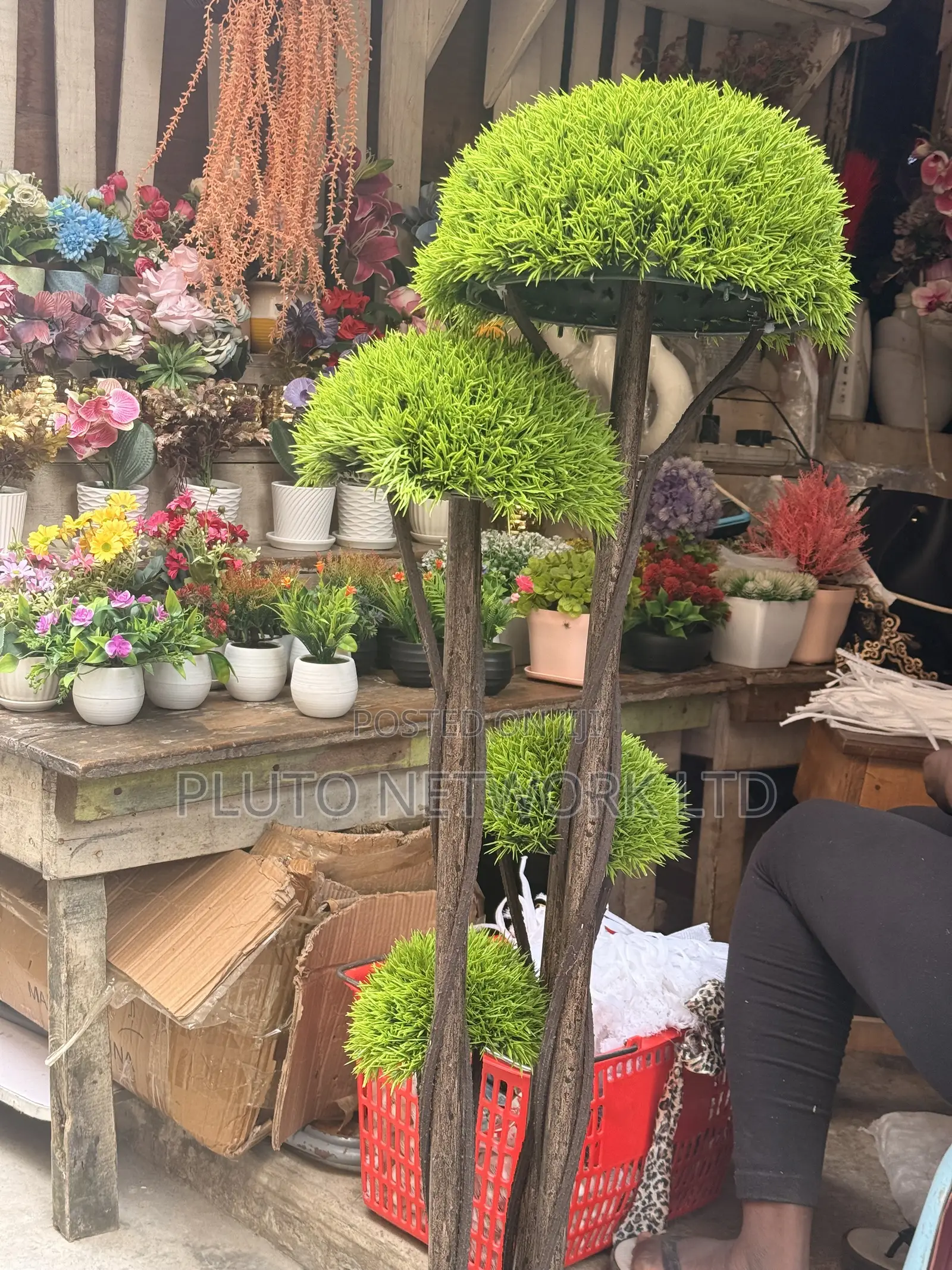 This Artificial Topiary Tree Features Multiple Tiered Green