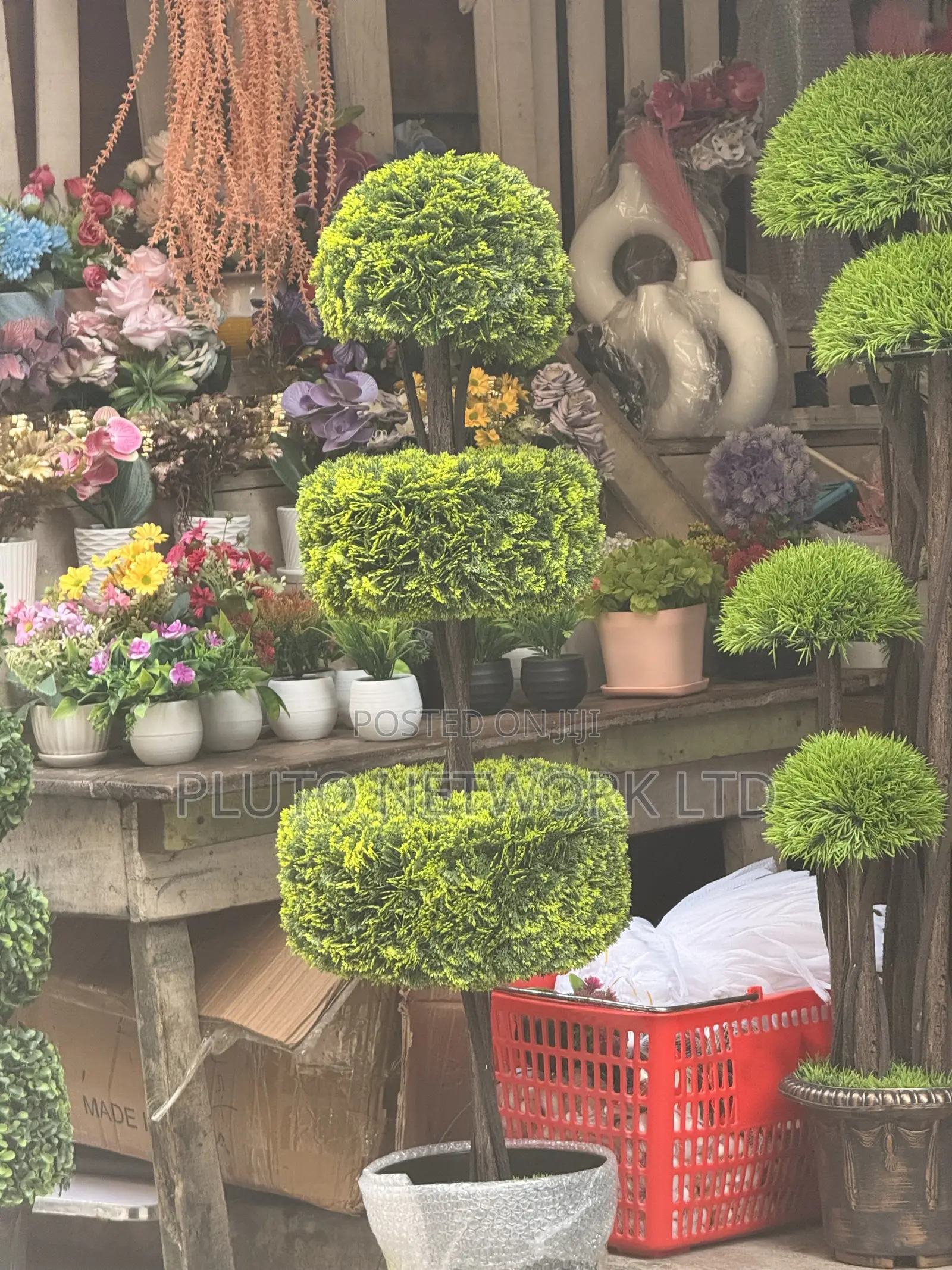 This Artificial Topiary Tree Features Multiple Tiered Green Ball-Shape