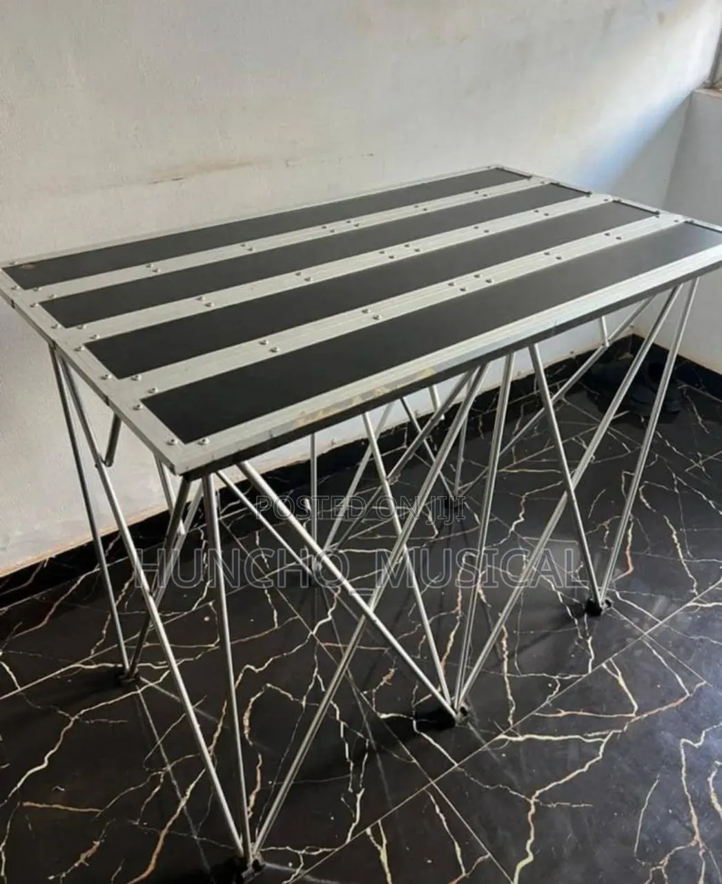 Portable Foldable DJ Stand Commonly Used in Events and DJ Setups.