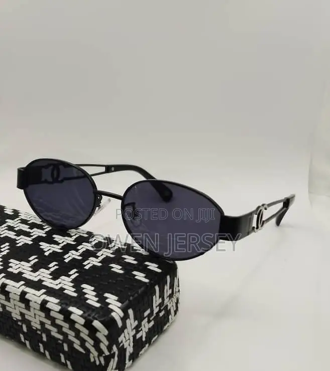 Gold-Tone Oval Eyeglasses With Black Temple Details.
