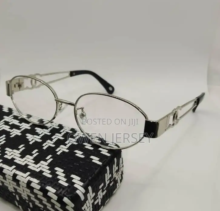 Gold-Tone Oval Eyeglasses With Black Temple Details.