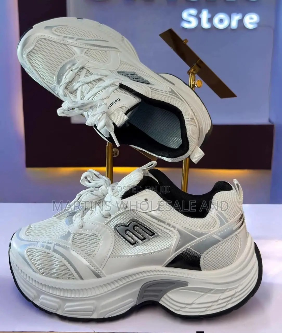 Stylish White and Silver Chunky Platform Sneakers Feature a Prominent
