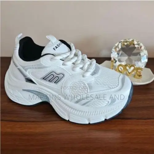 Stylish White and Silver Chunky Platform Sneakers Feature a Prominent