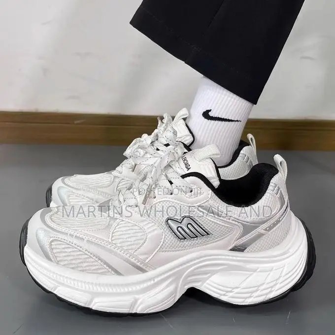 Stylish White and Silver Chunky Platform Sneakers Feature a Prominent