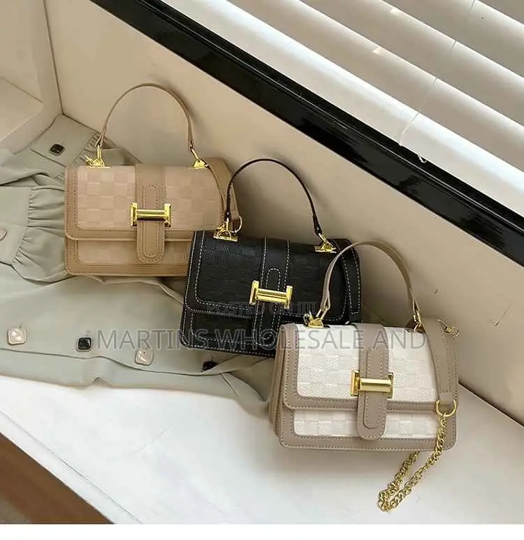 Chic Structured Handbag Features a Classic Checkered Pattern Accented