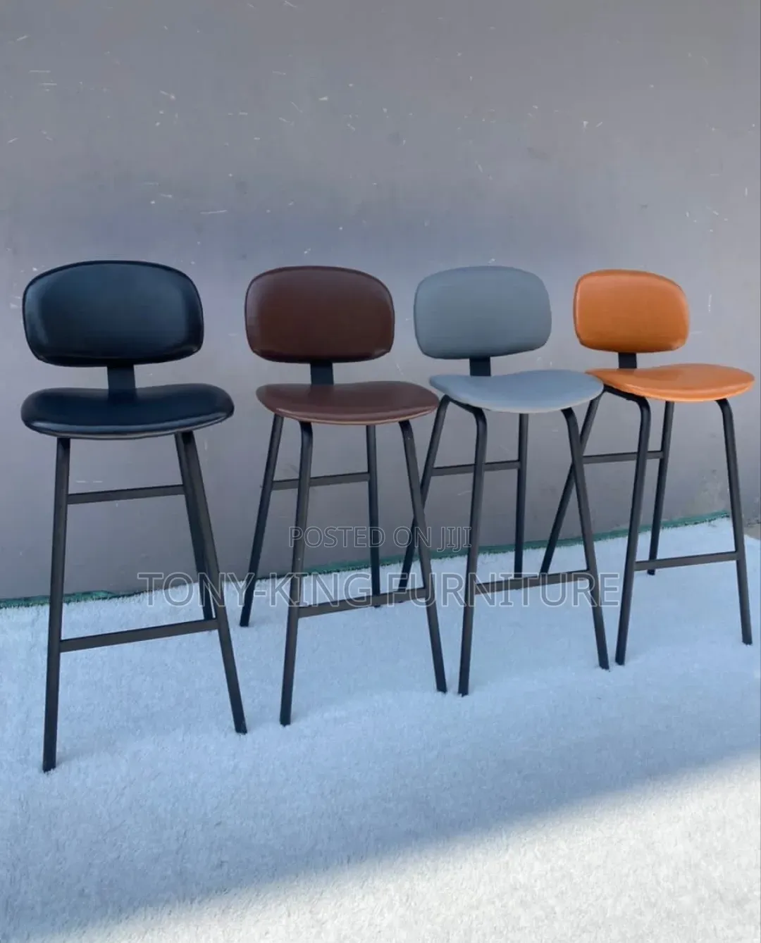 Modern Leather-Padded High Bar Stools Feature Sleek Black Iron Frames