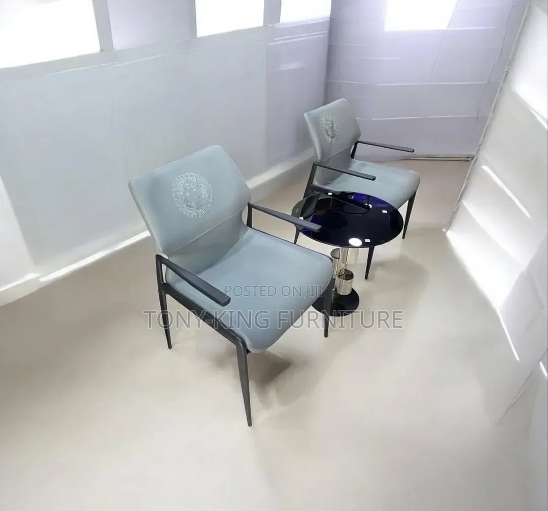 Modern Grey Armchair Features Sleek Dark Metal Framing