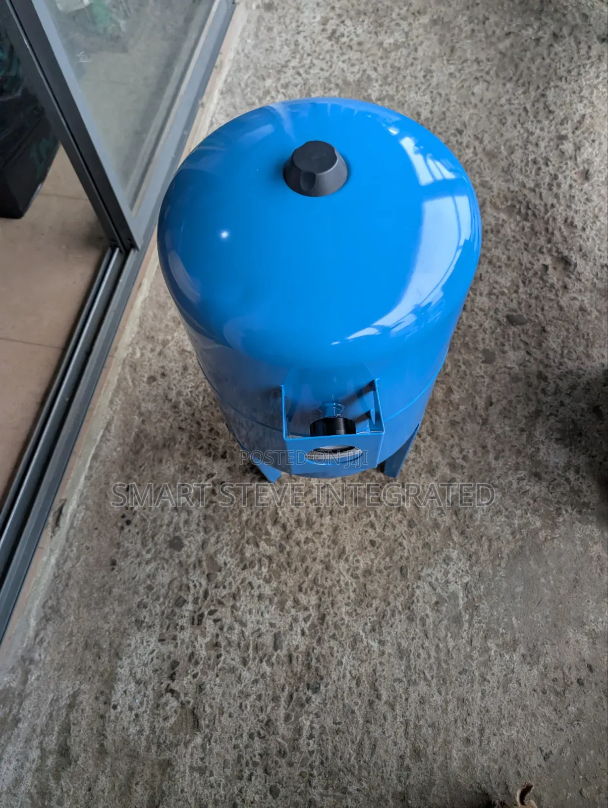 Blue Vertical Water Pressure Tank With Legs and a Built-in Pressures