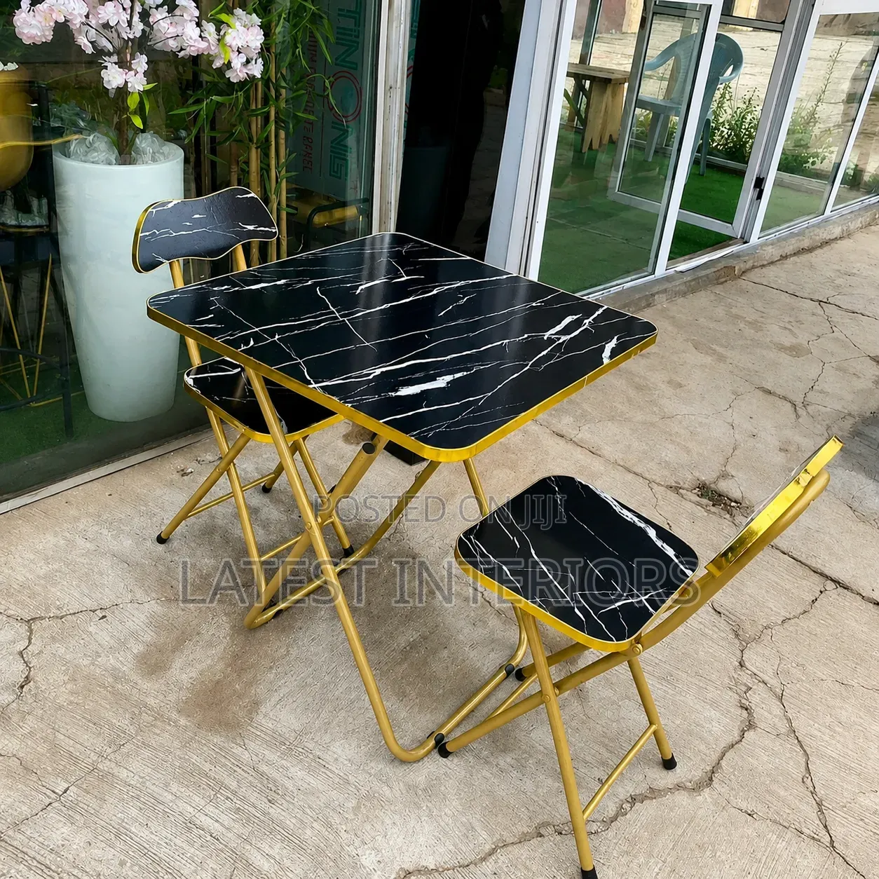 A Set of Foldable Coffee Table and Chairs
