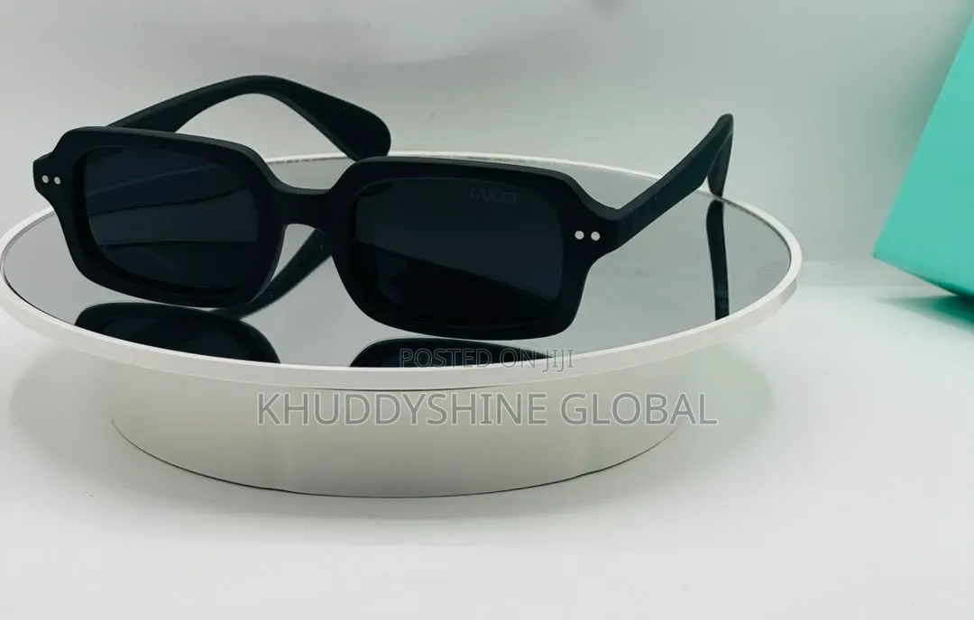 Black Rimless Rectangular Sunglasses Featuring Dark Tinted Lenses