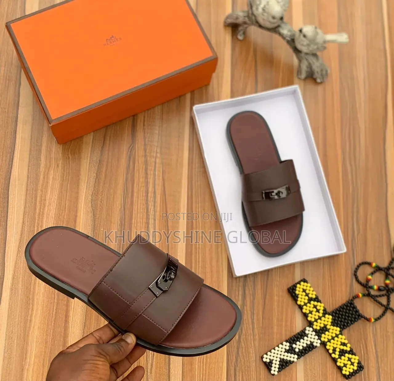 Brown Leather Slide Sandal With a Metallic Buckle Detail