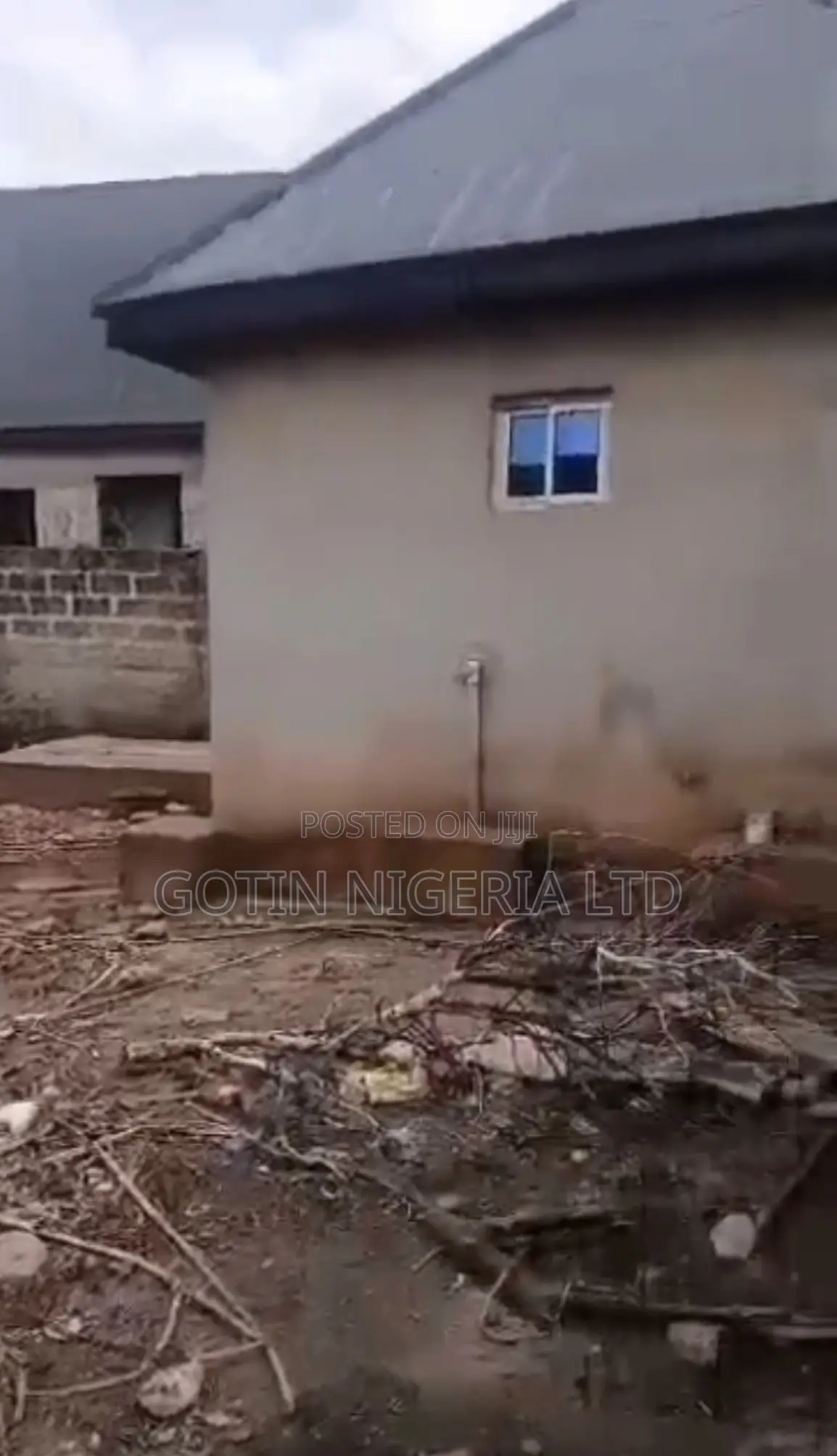 Fenced 100×100ft Land With Security House at Okabere