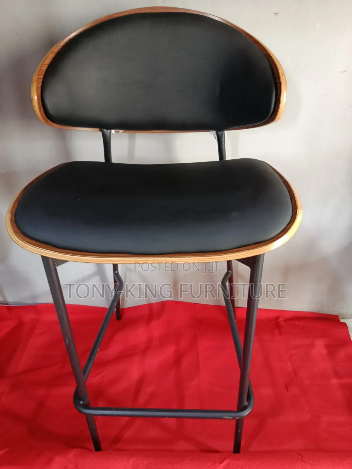 Modern Bentwood Bar Stool With a Black Padded Seat and Backrest.