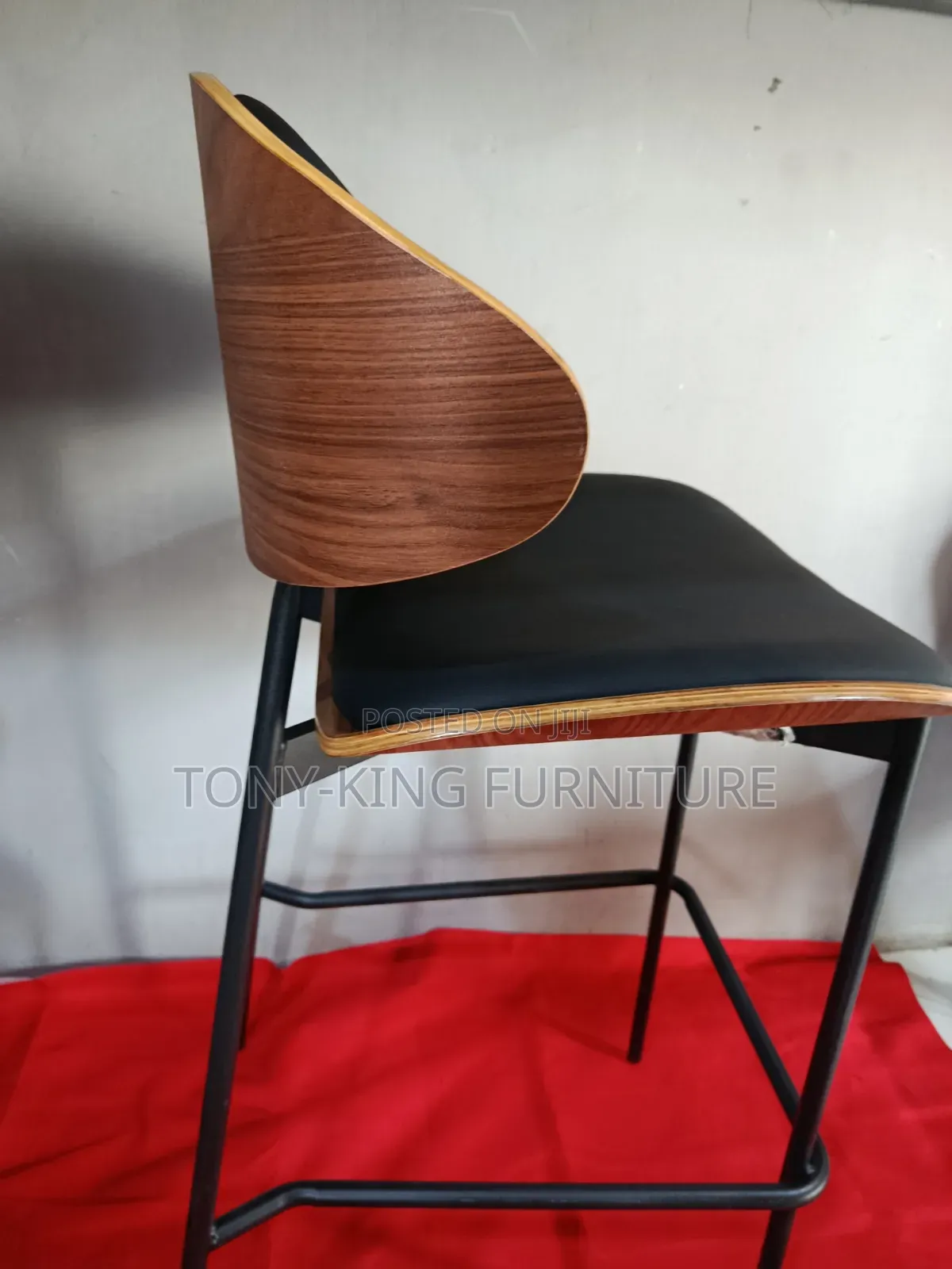 Modern Bentwood Bar Stool With a Black Padded Seat and Backrest.