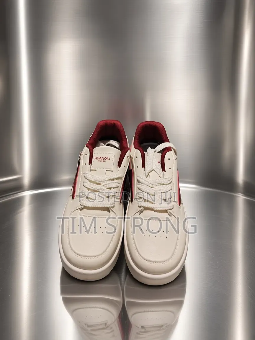 Timeless White Sneakers With Striking Red Accents on a Sleek Design