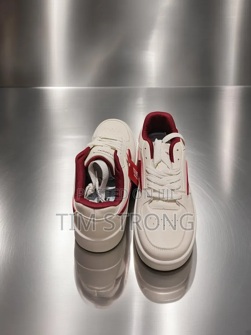 Timeless White Sneakers With Striking Red Accents on a Sleek Design