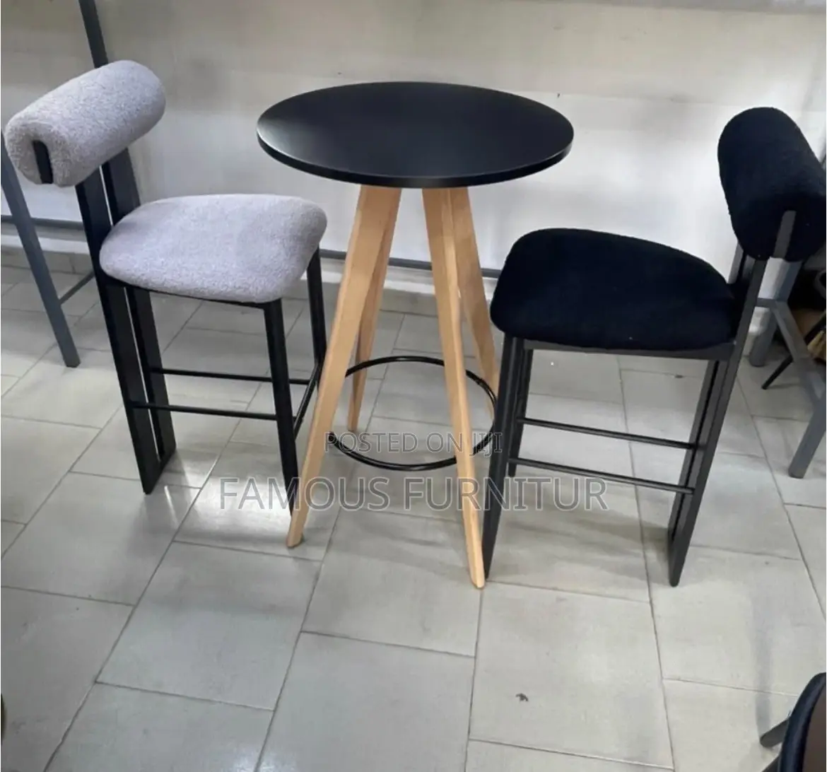 Modern Bar Set Featuring a Round Black-Topped Table Paired Barstools