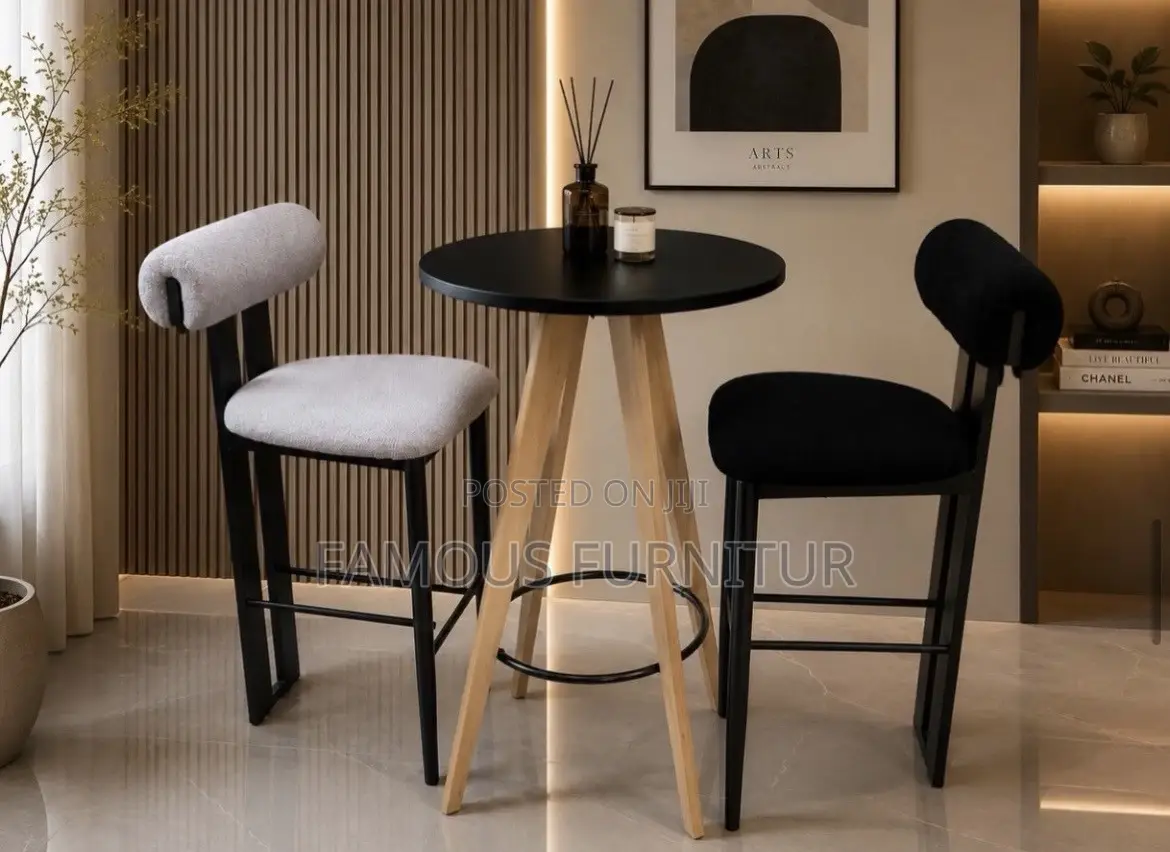 Modern Bar Set Featuring a Round Black-Topped Table Paired Barstools