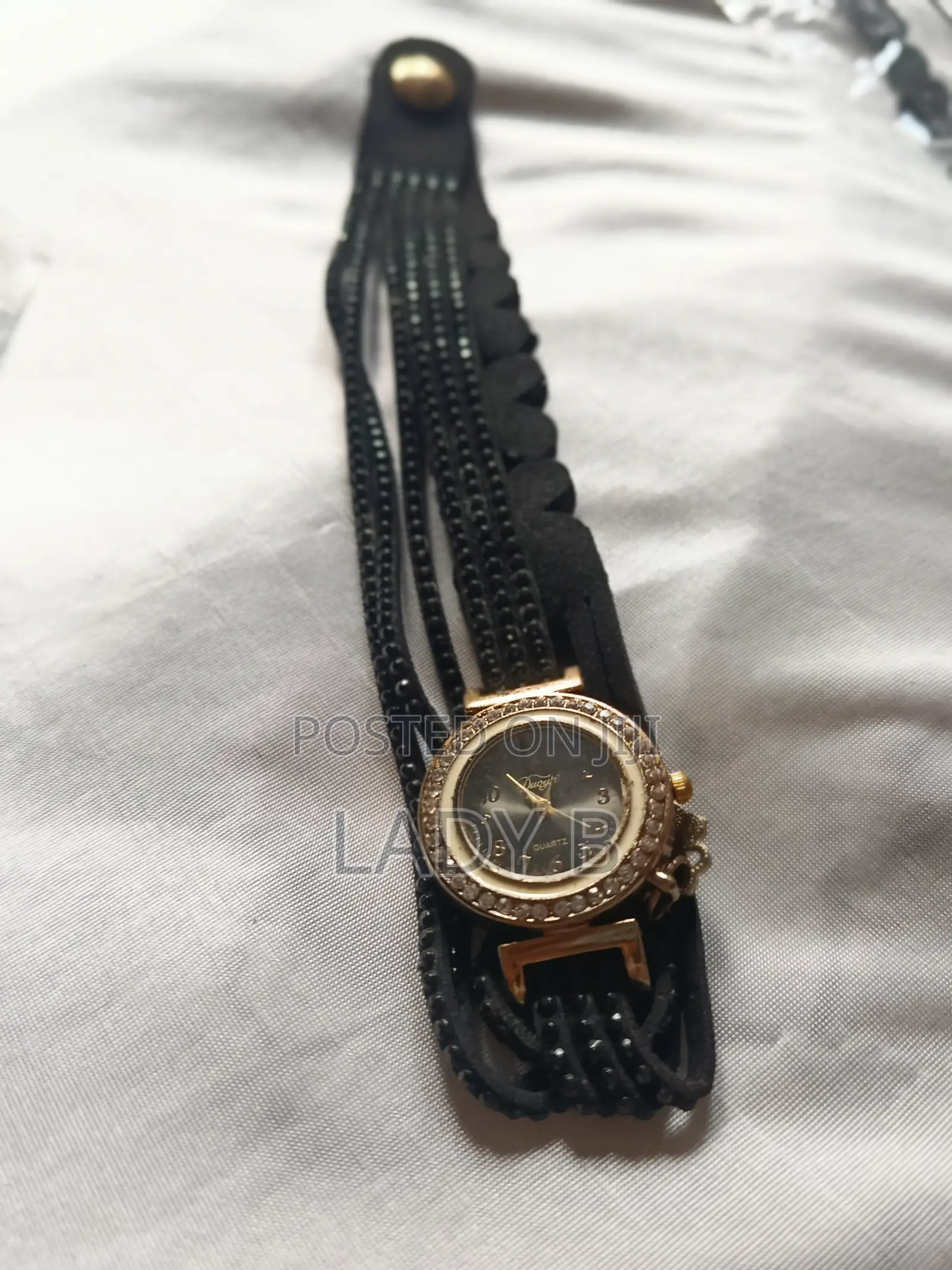 Elegant Black Charm Wristwatch With Gold Clover-Key Charm