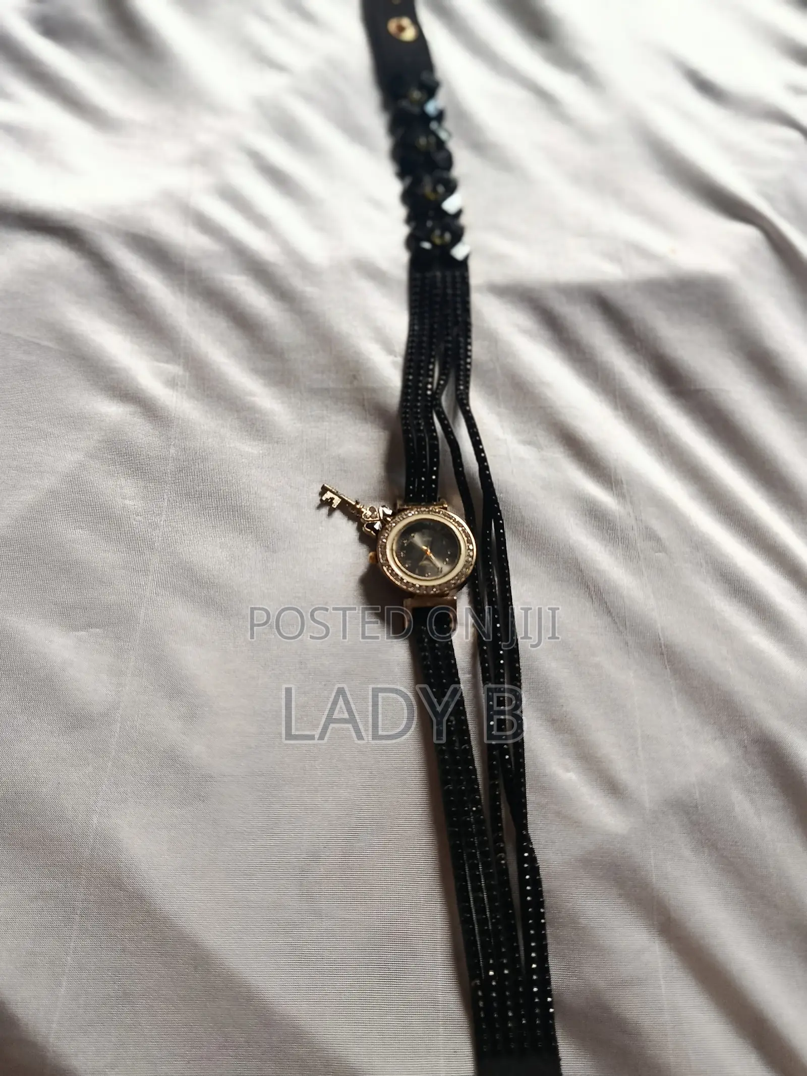 Elegant Black Charm Wristwatch With Gold Clover-Key Charm
