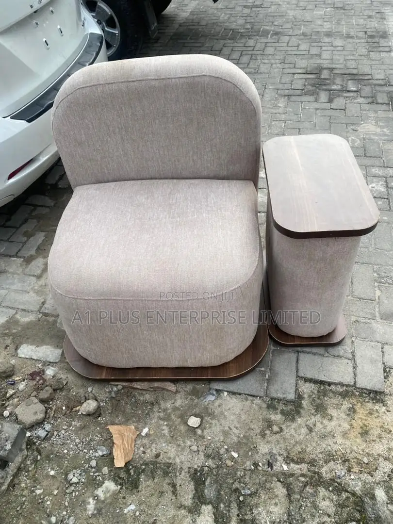 Modern Single Lounge Chair With an Attached Side Table.