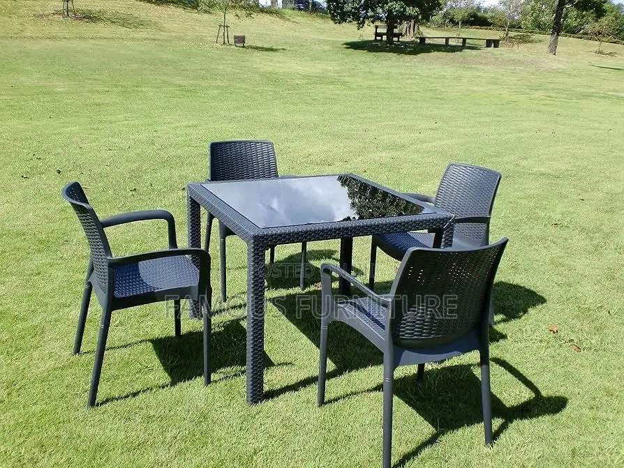 This Appears to Be a Black Rattan-Style Outdoor Dining Set