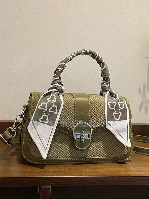 Dual-Textured Crossbody Bag Is Stylishly Accented With a Charming