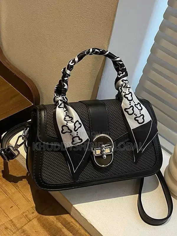 Dual-Textured Crossbody Bag Is Stylishly Accented With a Charming