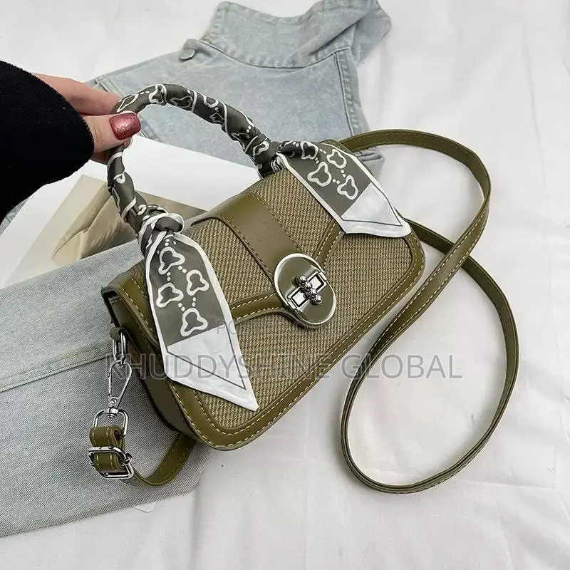 Dual-Textured Crossbody Bag Is Stylishly Accented With a Charming