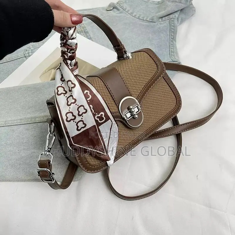 Dual-Textured Crossbody Bag Is Stylishly Accented With a Charming