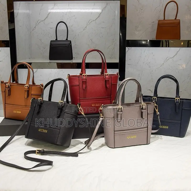 Top-Handle Guess Handbags Feature a Polished Gold-Tone Logo