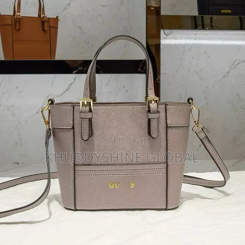 Top-Handle Guess Handbags Feature a Polished Gold-Tone Logo
