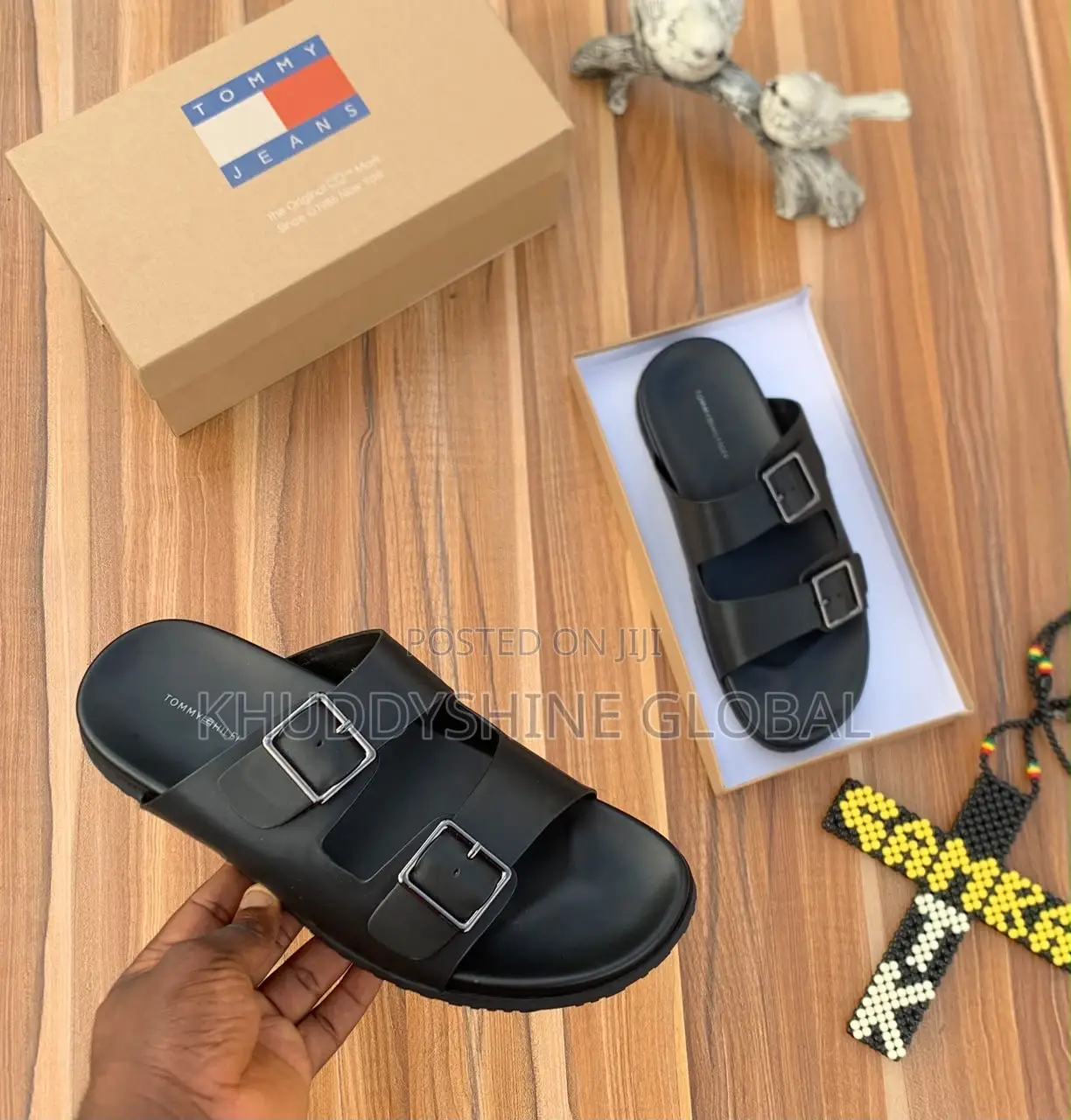 Men's Designer-Style Slip-on Sandals and Slides Arranged on a Wooden